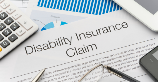 Document reads "disability insurance claim" on a messy desk